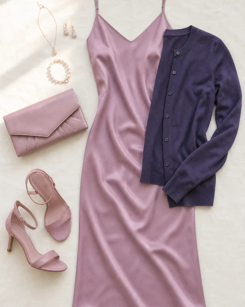 Light Summer evening outfit: slip dress in Orchid #C28CAA, fine-knit cardigan in Navy Purple #4D4470, heels in Dusty Rose #C7A5B8, clutch in Dusty Rose #C7A5B8
